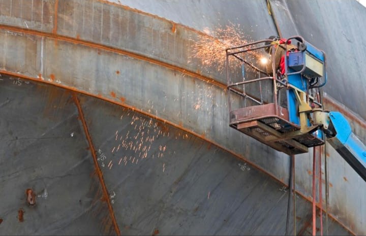 Marine welder working on a ship hull